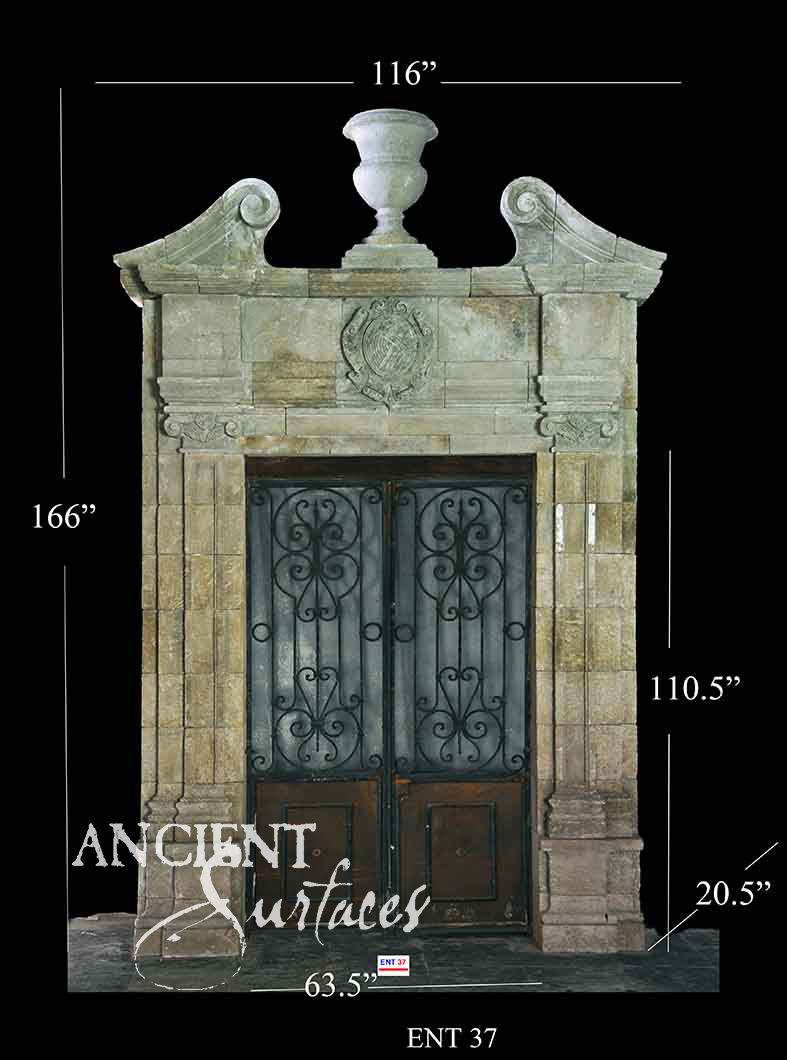 Reclaimed antique limestone entryway from Ancient Surfaces with a broken pediment, a carved stone urn finial and a shield cartouche, photographed with dealer measurements marked, code ENT 37