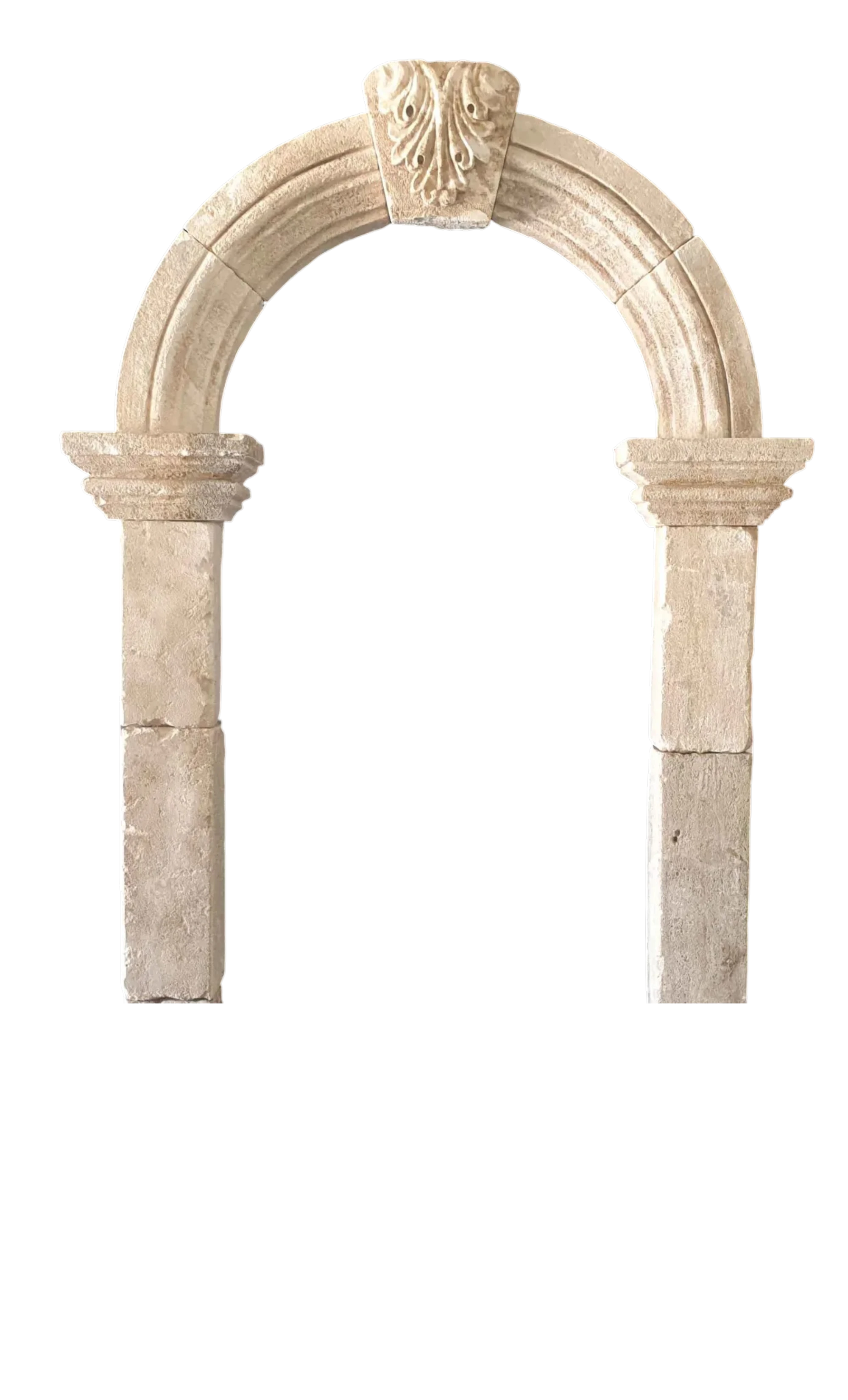Reclaimed antique limestone entryway from Ancient Surfaces with a rounded arch, carved central keystone and tall plain stone jambs